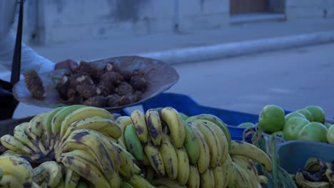 cuban peddler selling cocoyams in the street, focus back to front slow motion