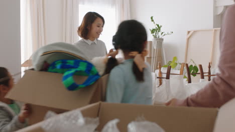 happy-asian-family-moving-into-new-home-owners-with-children-helping-parents-move-into-house-carrying-boxes-enjoying-teamwork-together-with-kids-real-estate-property-investment-4k-footage