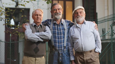 Portrait-Of-The-Three-Old-Cheerful-Men-Hugging-And-Smiling-While-Posing-To-The-Camera