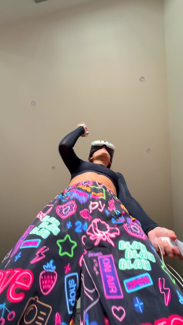 Woman Dancing in VR Headset with Colorful Pants