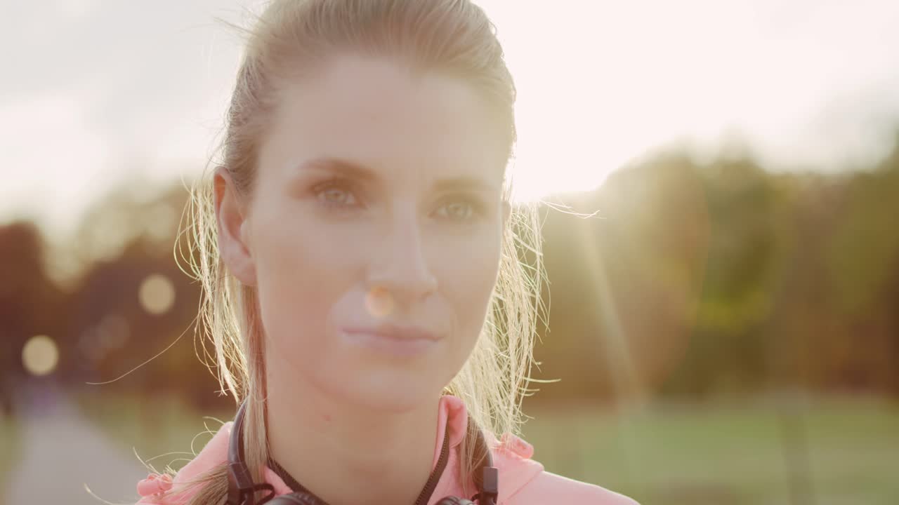 Handheld view of serious woman after jogging training