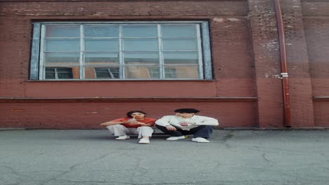 young couple relaxing outdoors on skateboard