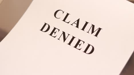 claim denied text printed on the sheet paper. claim denied concept.