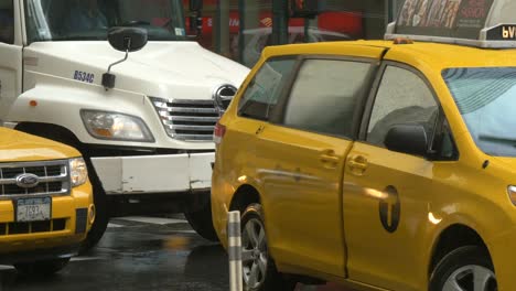 lady getting into taxi in rain in new york