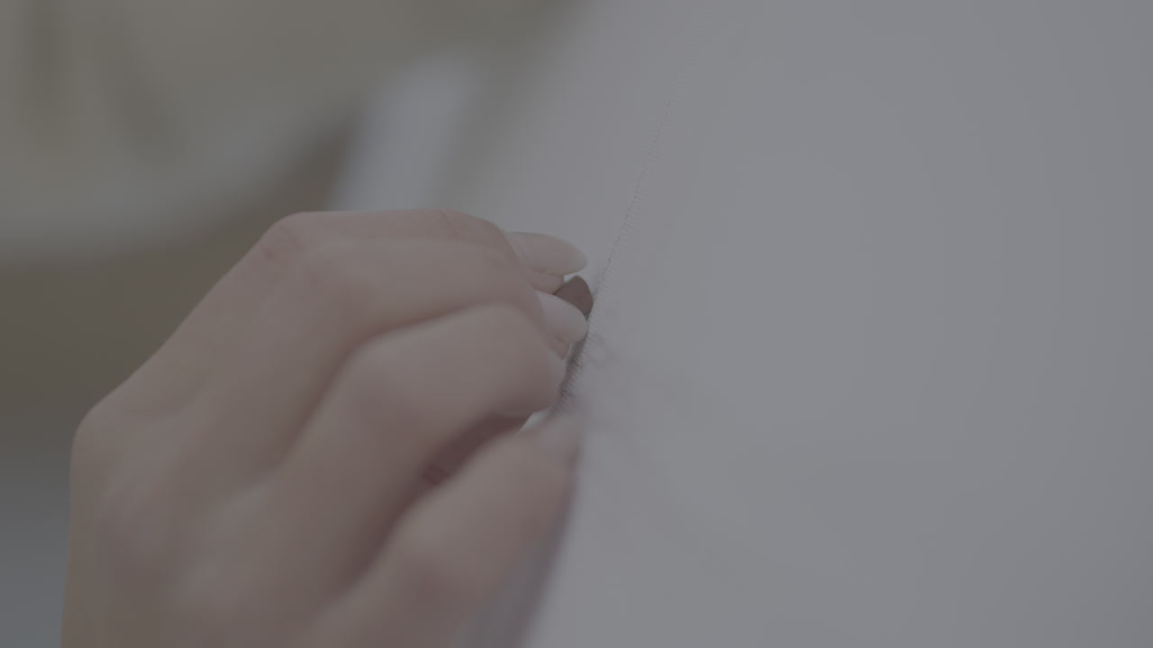 Person sewing or fixing a garment