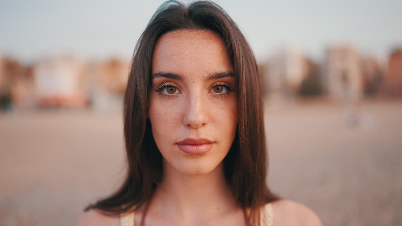 Portrait of a beautiful young woman with freckles