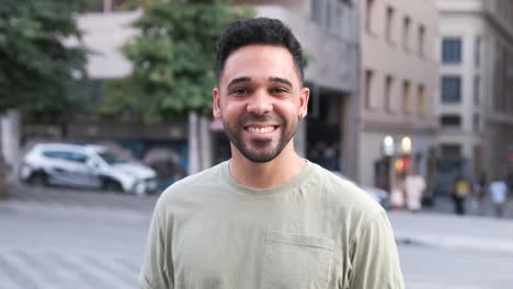 happy man smiling and nodding head while standing on city street