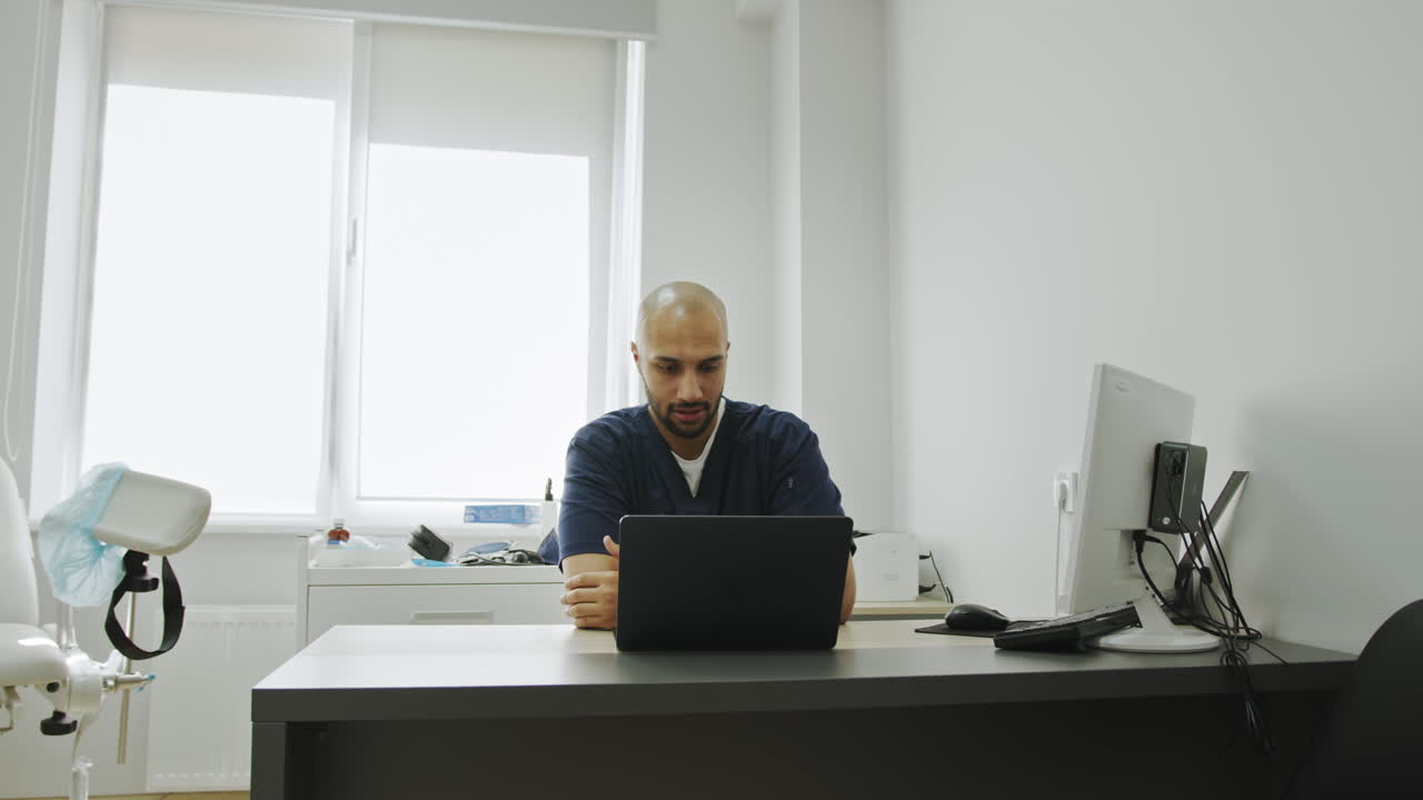 Doctor using laptop in modern office