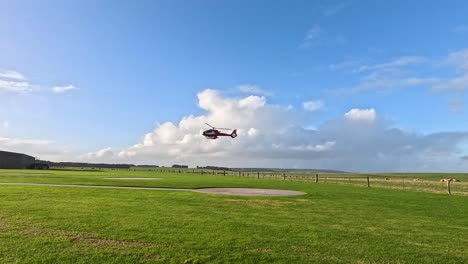 helicopter descends onto a grassy field