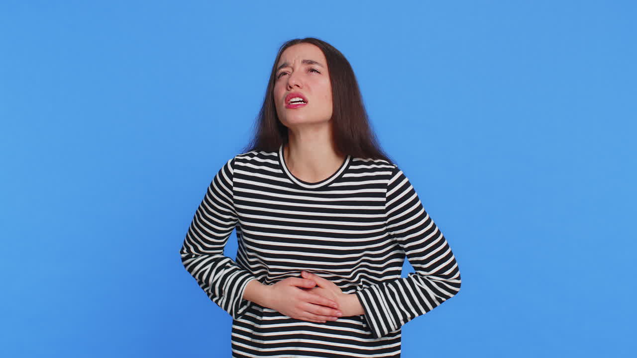 Sick ill caucasian woman suffering from period cramps stomach abdominal ache menstrual pain diarrhea