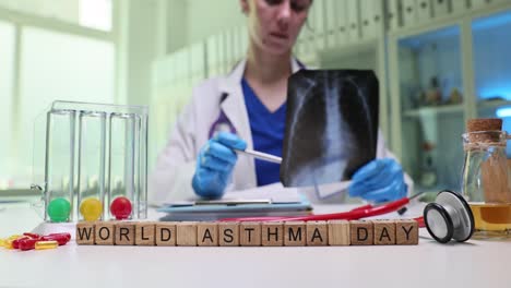 a doctor examines a lung x-ray on world asthma day