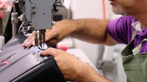 Italian-shoemaker,-making-leather-bag-with-traditional-machines