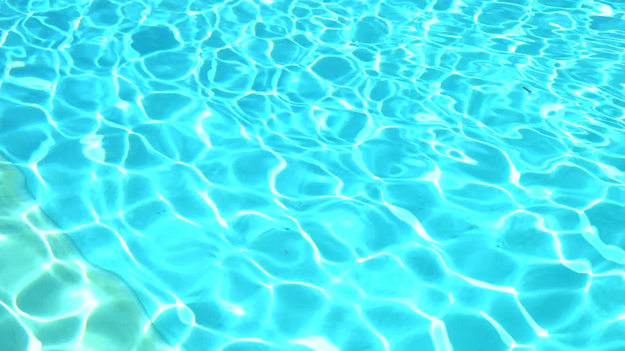 Water surface texture, Slow motion clean swimming pool ripples and wave, Refraction of sunlight top view texture sea side white sand, sun shine water background. Water Caustic Background.