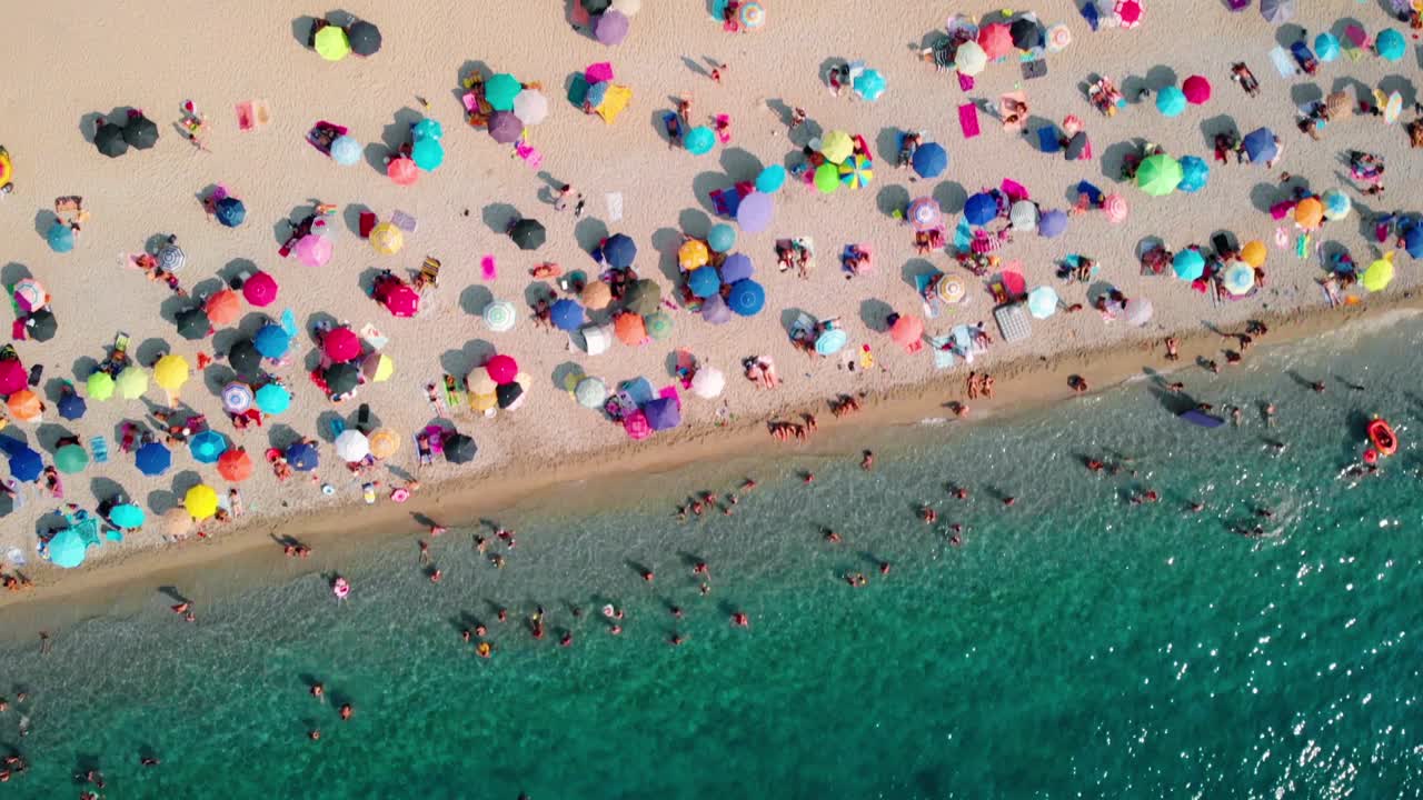 Aerial View of Crowded Beach with Colorful Umbrellas