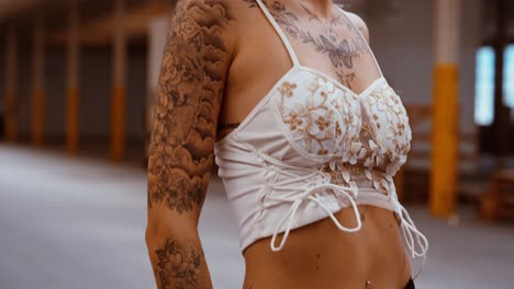 Urban fashion portrait of tattooed model in industrial space, gimbal movement, slow motion