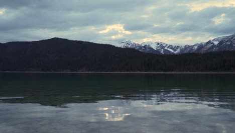 Calm-tranquil-Lake-Eibsee-clear-rippling-water-under-alps-woodland-mountain-range-Bavaria