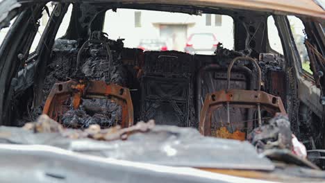 charred seat frames and melted interior reveal aftermath of severe vehicle fire