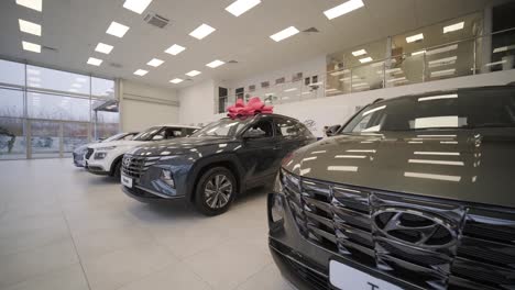 car dealership with row of anonymous new vehicle on sale. showroom with shiny auto. automotive