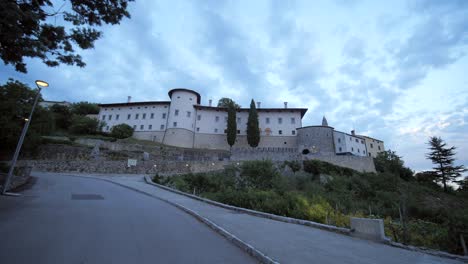 wide-dolly-shot-of-renovated-Stanjel-castle-at-blue-light,-summer-evening