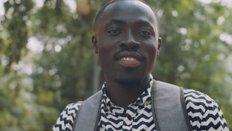 Portrait-of-Positive-Afro-American-Male-Student-Outdoors