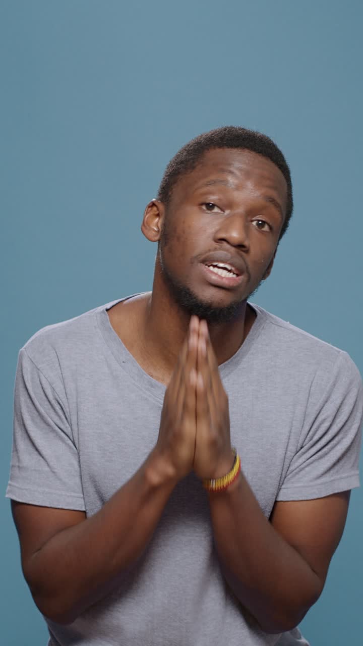 Man praying with hands together
