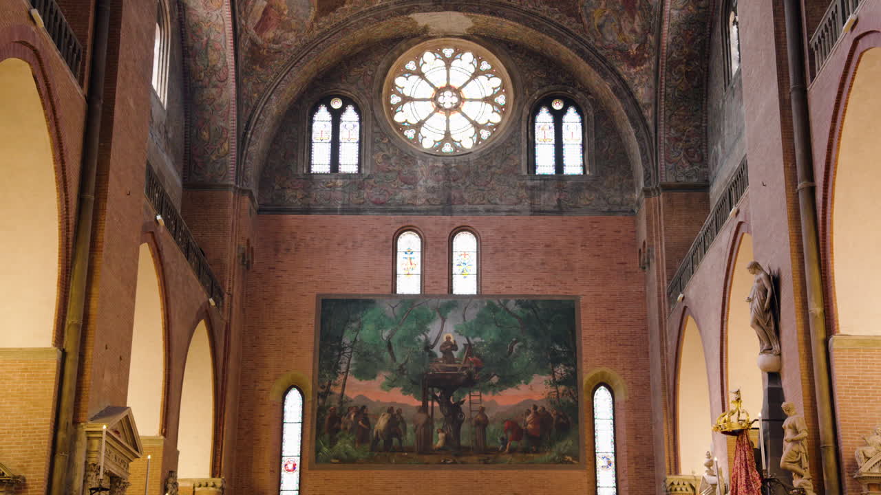 Interior Facade Of Basilica of Saint Anthony of Padua With A Rose Window And Painting Of Religious Scene In Padua, Veneto, Northern Italy. - wide shot