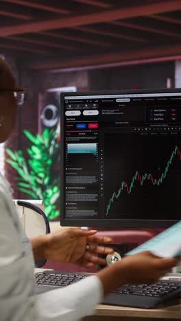 vertical video day trader using pc to purchase and sell stocks, browsing through documents