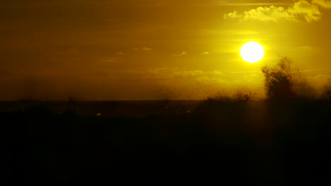 The-sunset-behind-waves-as-they-crest-and-break-in-slow-motion-at-sunset-1