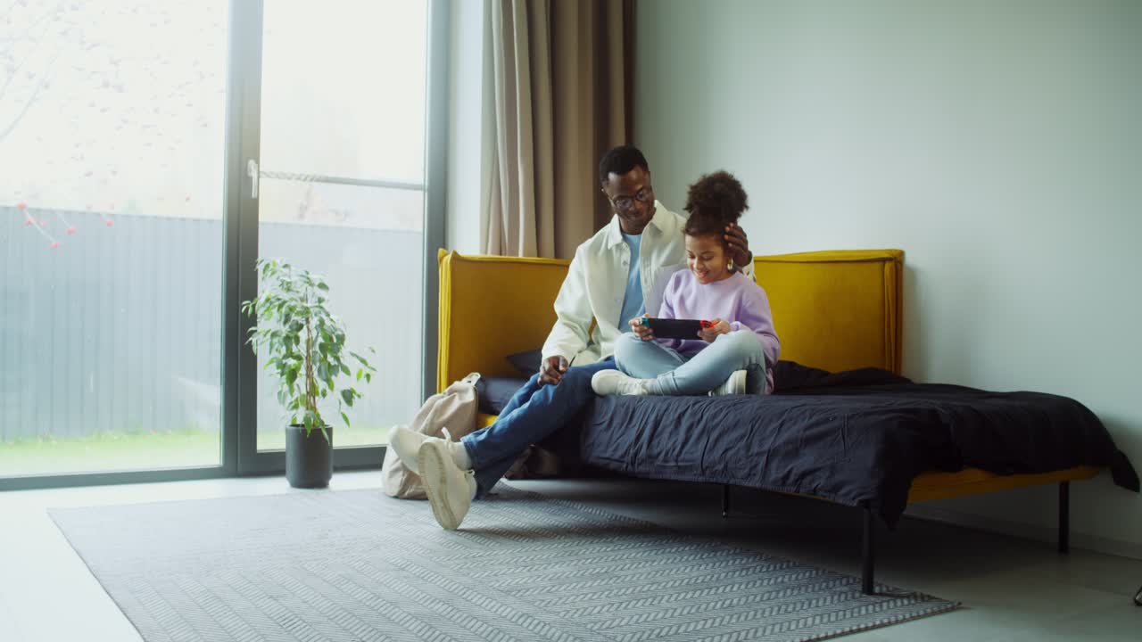 Father and Daughter Playing Video Games at Home