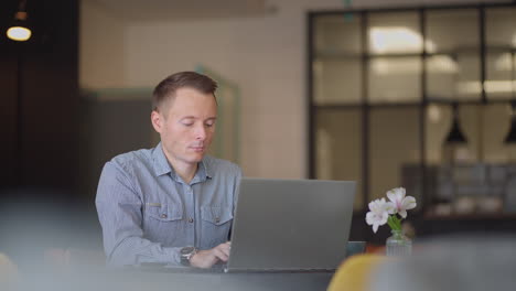 Young-freelancer-man-working-on-computer-at-home.-Casual-concentrated-entrepreneur-developing-new-project-while-working-on-laptop-at-home.-Male-professional-typing-laptop-keyboard-at-office-workplace