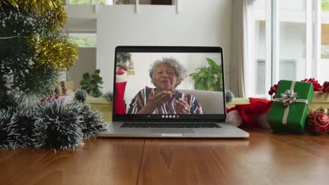 Lächelnde-Afroamerikanische-Frau,-Die-Sich-Bei-Einem-Weihnachtsvideoanruf-Auf-Dem-Laptop-Küsst