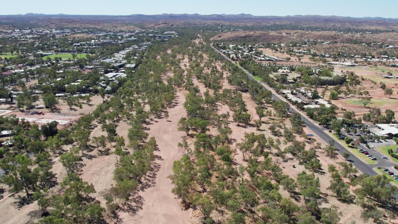 Aerial view of the dry Todd River in the full sun in Alice Springs, Mparntwe. Northern Territory, Australia. August 2022.