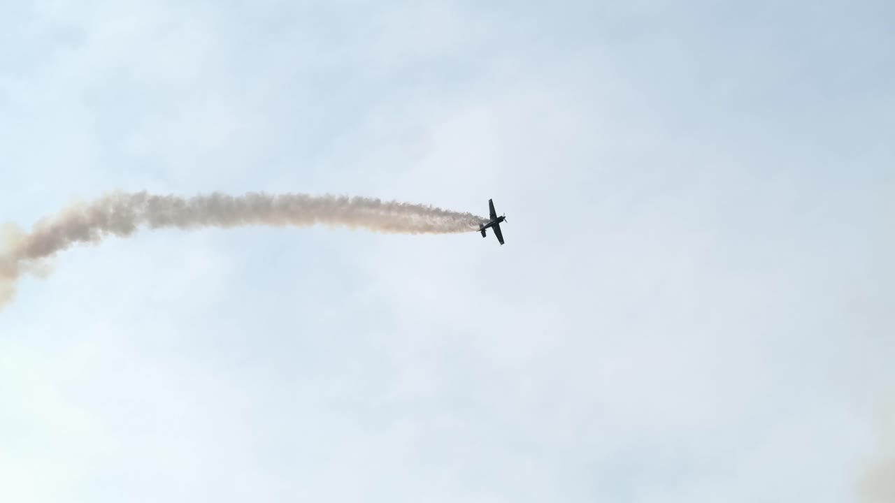 Aerobatics Airplane Performs Looping and Stunts at Airshow SLOMO