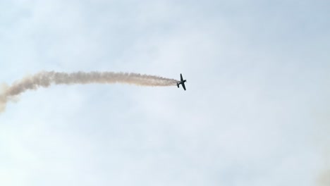 aerobatics airplane performs looping and stunts at airshow slomo