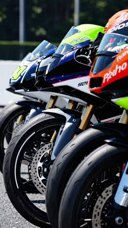 close-up view of racing motorcycles lined up on a track.