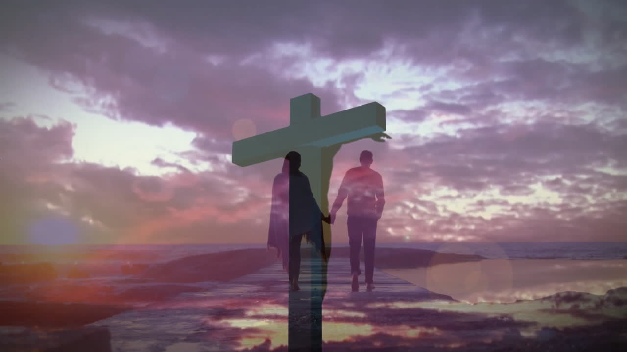 Walking towards large cross, silhouetted couple under vibrant sunset sky animation