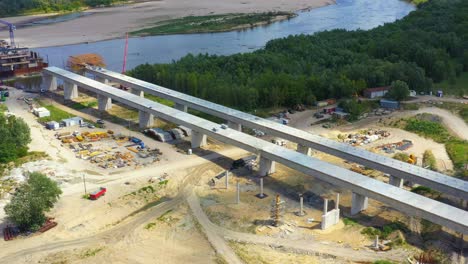 aerial shot passing over a bridge construction project at sunset in vistula near warsaw