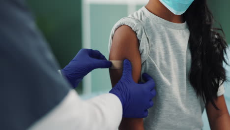 child getting vaccinated by a doctor