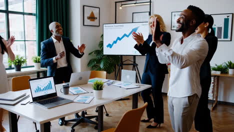 diverse business team celebrating success in a modern office