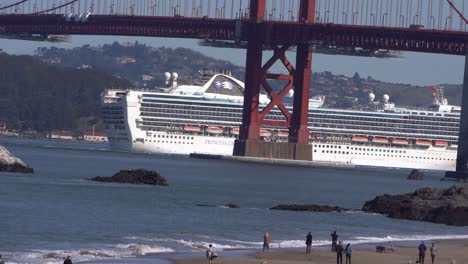 cruise ship passes under golden gate bridge