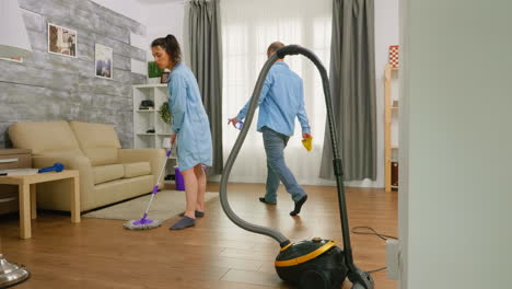 man wiping dust of the furniture