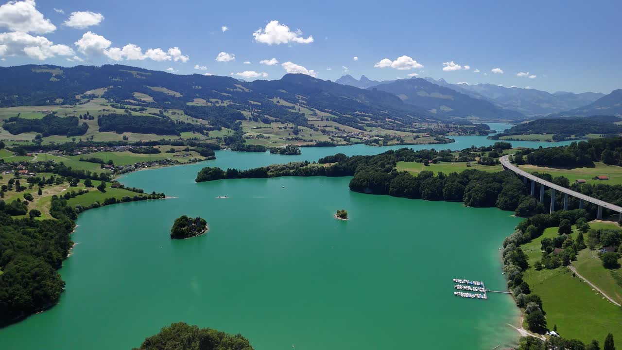 Lake Gruyère artificial man-made turquoise blue water Greyerzersee Switzerland aerial drone