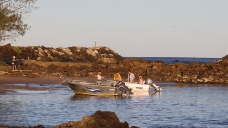 sequence of boats maneuvering in a rocky inlet