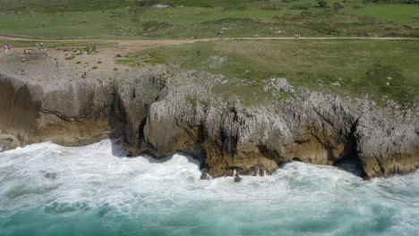 cinematic aerial trucking pan along weathered layers of limestone rock in asturias spain