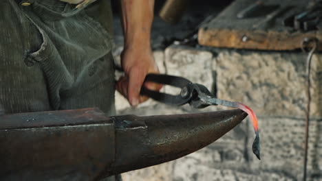 a blacksmith makes a product of iron hits the anvil with a hammer antique crafts