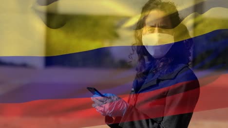 Colombian-flag-waving-woman-wearing-face-mask-holding-smartphone