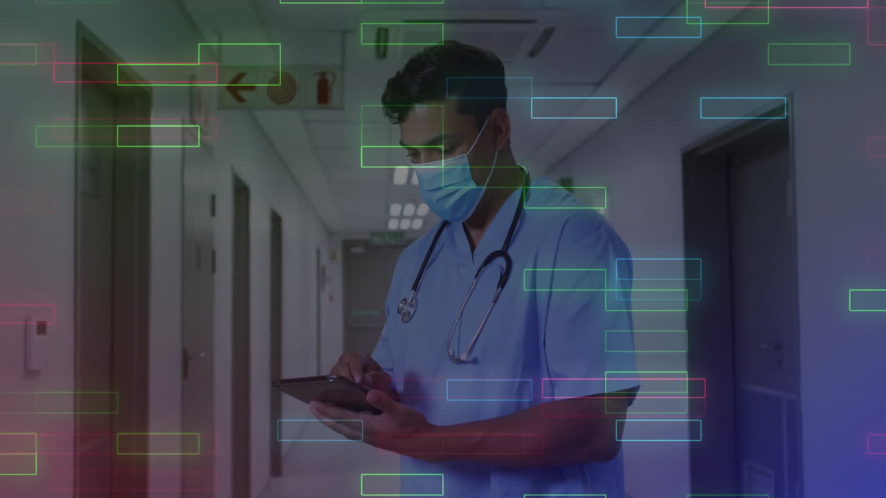 Male healthcare worker tapping tablet in hospital corridor, showing colored data streams