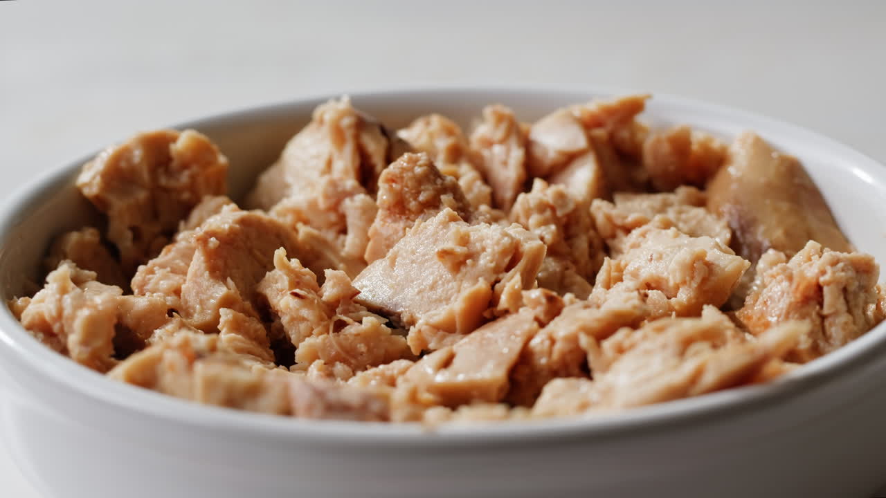 Smoked cod liver in oil in open tin can with fresh greens on wooden table. Seafoods delicacy. High quality 4k footage