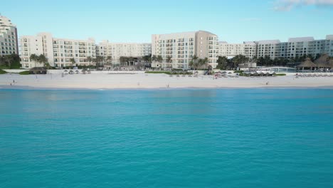 A luxurious beach resort in cancun with clear turquoise water, aerial view, playa delfines