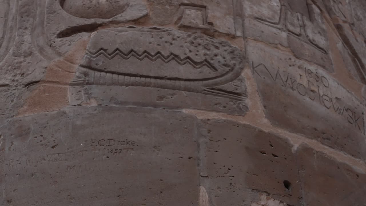 Close up of Ancient Egyptian Temple column inscription on it from past travelers